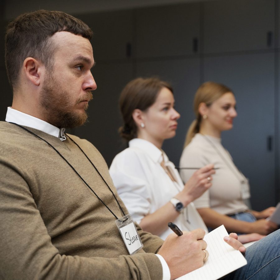 people at the conference taking notes